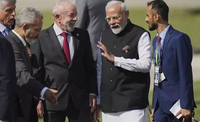 India's Prime Minister Narendra Modi, second from right, chats with Brazilian President Luiz Inacio Lula da Silva during the 17th annual BRICS summit in Rio de Janeiro, Sunday, July 6, 2025. (AP Photo/Silvia Izquierdo)