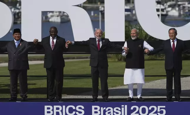 From left, Indonesia's President Prabowo Subianto, South Africa's President Cyril Ramaphosa, Brazilian President Luiz Inacio Lula da Silva, India's Prime Minister Narendra Modi and China's Premier Li Qiang pose for a group photo at the 17th annual BRICS summit in Rio de Janeiro, Sunday, July 6, 2025. (AP Photo/Silvia Izquierdo)