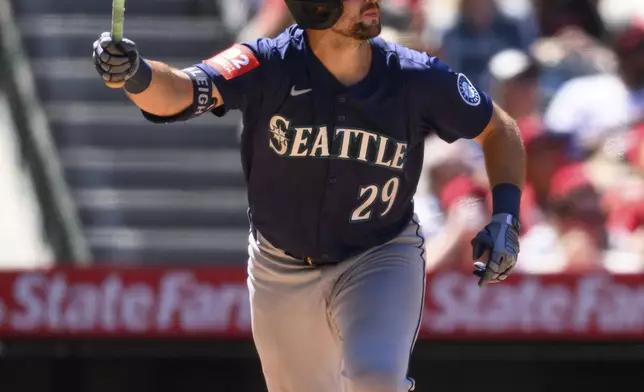 Seattle Mariners' Cal Raleigh hits a home run during the seventh inning of a baseball game against the Los Angeles Angels, Sunday, July 27, 2025, in Anaheim, Calif. (AP Photo/William Liang)