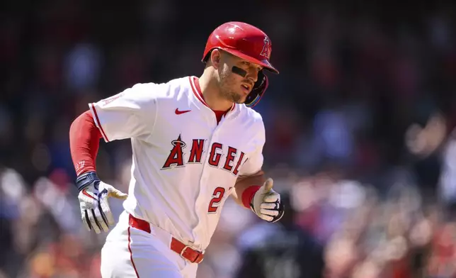 Los Angeles Angels' Mike Trout runs after hitting a home run during the fifth inning of a baseball game against the Seattle Mariners, Sunday, July 27, 2025, in Anaheim, Calif. (AP Photo/William Liang)