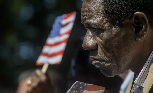 Stephen Saji, from Zimbabwe, listens as former California Gov. Arnold Schwarzenegger delivers keynote remarks to new citizens on Independence Day at George Washington's Mount Vernon, Friday, July 4, 2025, in Alexandria, Va. (AP Photo/Rod Lamkey, Jr.)