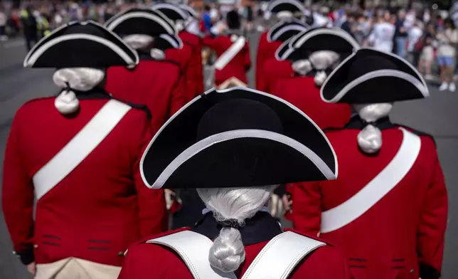 Members of the U.S. Army Old Guard Fife and Drum Corps stand before performing at Fourth of July festivities at the National Archives, Friday, July 4, 2025, in Washington. (AP Photo/Mark Schiefelbein)