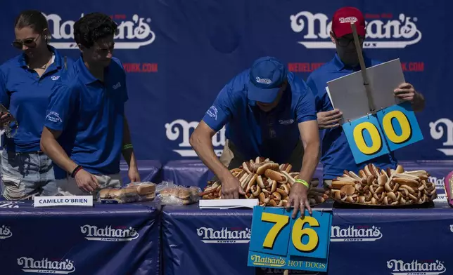 People prepare hot dogs ahead of the 2025 Nathan's Famous Fourth of July hot dog eating contest in the Coney Island section of the Brooklyn borough of New York, Thursday, July 4, 2025. (AP Photo/Yuki Iwamura)