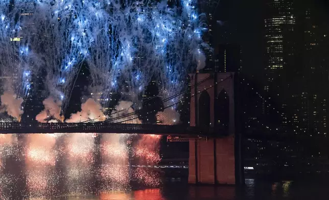 Fireworks light up the sky above the Brooklyn Bridge during the Macy's Fourth of July fireworks show on Friday, July 4, 2025, in New York. (AP Photo/Yuki Iwamura)