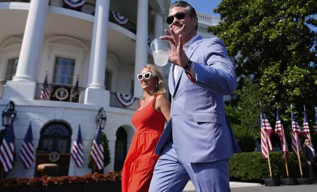 Defense Secretary Pete Hegseth and his wife Jennifer Rauchet arrive before President Donald Trump and first lady Melania Trump attend a Fourth of July celebration on the South Lawn at the White House, Friday, July 4, 2025, in Washington. (AP Photo/Julia Demaree Nikhinson)