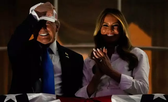 President Donald Trump and first lady Melania Trump watch a Fourth of July fireworks display from the Truman Balcony of the White House, Friday, July 4, 2025, in Washington. (AP Photo/Julia Demaree Nikhinson)