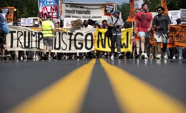 Demonstrators protesting against President Donald Trump and his policies march toward the White House on Friday, July 4, 2025, in Washington. (AP Photo/Mark Schiefelbein)