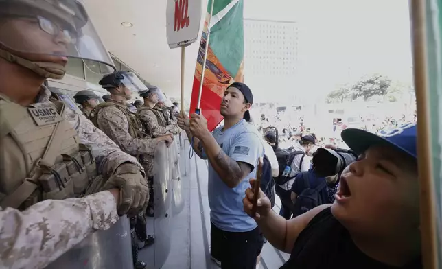Protesters confront Marines outside the Federal Building on Friday, July 4, 2025 in Los Angeles. (AP Photo/Jill Connelly)
