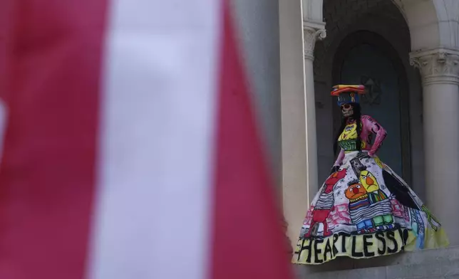 A demonstrator take part in a protest at City Hall against President Donald Trump's policies on Friday, July 4, 2025 in Los Angeles. (AP Photo/Jill Connelly)