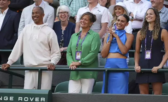 Shelton's parents Bryan Shelton and Lisa Witsken Shelton, from left, girlfriend Trinity Rodman and sister Emma Shelton watch Ben Shelton of the U.S. winning the men's singles fourth round match against Lorenzo Sonego of Italy at the Wimbledon Tennis Championships in London, Monday, July 7, 2025.(AP Photo/Kirsty Wigglesworth)