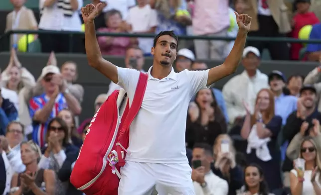 Lorenzo Sonego of Italy waves to the crowd after losing the men's singles fourth round match against Ben Shelton of the U.S. at the Wimbledon Tennis Championships in London, Monday, July 7, 2025.(AP Photo/Kirsty Wigglesworth)