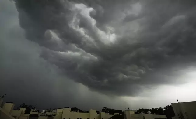 FILE - Monsoon clouds gather over New Delhi's skyline, India, June 28, 2025. (AP Photo/Manish Swarup, File)