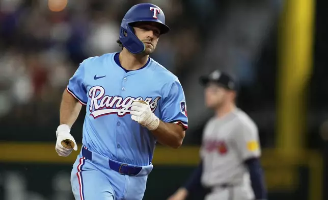 Texas Rangers' Josh Smith rounds the bases after hitting a two-run home run against the Atlanta Braves in the second inning of a baseball game Sunday, July 27, 2025, in Arlington, Texas. (AP Photo/Tony Gutierrez)