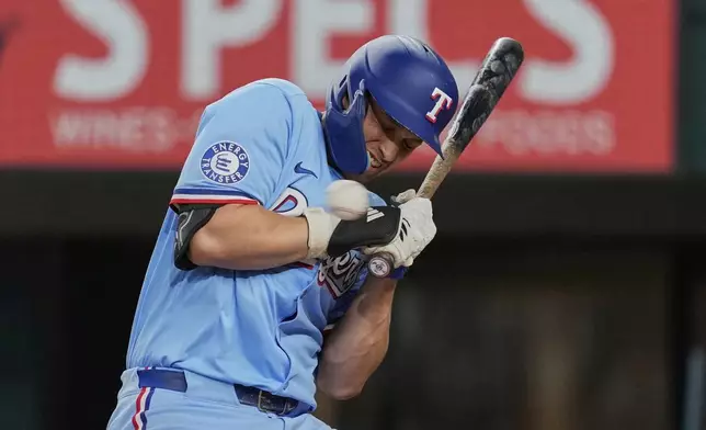 Texas Rangers' Corey Seager backs away from an inside pitch in the third inning of a baseball game against the Atlanta Braves, Sunday, July 27, 2025, in Arlington, Texas. (AP Photo/Tony Gutierrez)