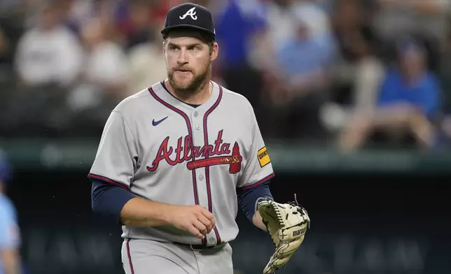 Atlanta Braves starting pitcher Bryce Elder walks to the dugout after being pulled in the third inning of a baseball game against the Texas Rangers Sunday, July 27, 2025, in Arlington, Texas. (AP Photo/Tony Gutierrez)