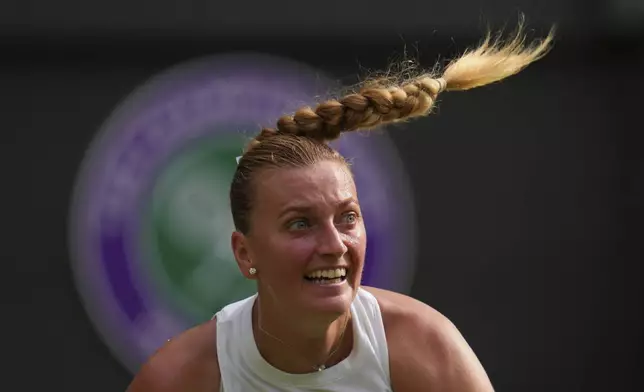 Petra Kvitova of Czech Republic returns the ball to Emma Navarro of the U.S. during their first round women's single match at the Wimbledon Tennis Championships in London, Tuesday, July 1, 2025.(AP Photo/Kirsty Wigglesworth)