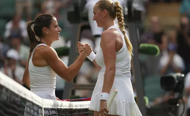 Emma Navarro of the U.S. left and Petra Kvitova of Czech Republic shake hands after their first round women's single match at the Wimbledon Tennis Championships in London, Tuesday, July 1, 2025.(AP Photo/Kirsty Wigglesworth)