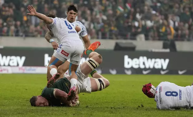 South Africa's Jasper Wiese, left, falls to the ground after by Italy's Ross Vintcent, right, during a rugby championship test match between South Africa and Italy, at the Nelson Mandela Bay stadium in Gqeberha, South Africa, Saturday, July 12, 2025. (AP Photo/Themba Hadebe)