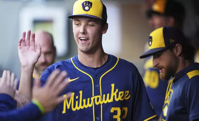 Milwaukee Brewers starting pitcher Jacob Misiorowski is greeted in the dugout after being taken out of a baseball game against the Seattle Mariners during the fourth inning Tuesday, July 22, 2025, in Seattle. (AP Photo/Lindsey Wasson)