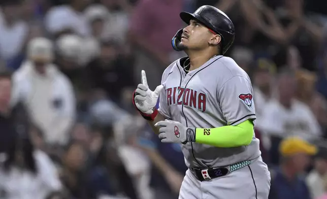 Arizona Diamondbacks' Josh Naylor celebrates while rounding the bases after hitting a two-run home run during the fifth inning of a baseball game against the San Diego Padres Monday, July 7, 2025, in San Diego. (AP Photo/Orlando Ramirez)