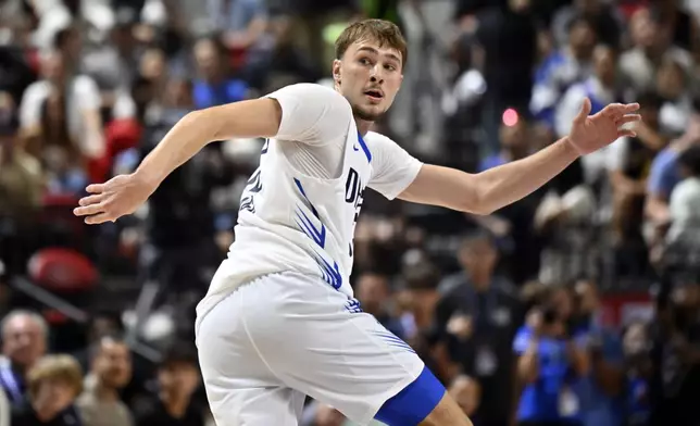 Dallas Mavericks forward Cooper Flagg (32) looks back as he runs up court against the Los Angeles Lakers during the first half of an NBA summer league basketball game Thursday, July 10, 2025, in Las Vegas. (AP Photo/David Becker)