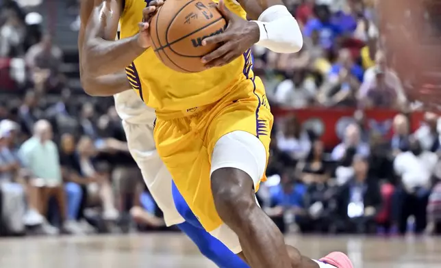 Los Angeles Lakers guard Bronny James (9) drives the ball against the Dallas Mavericks during the first half of an NBA summer league basketball game Thursday, July 10, 2025, in Las Vegas. (AP Photo/David Becker)