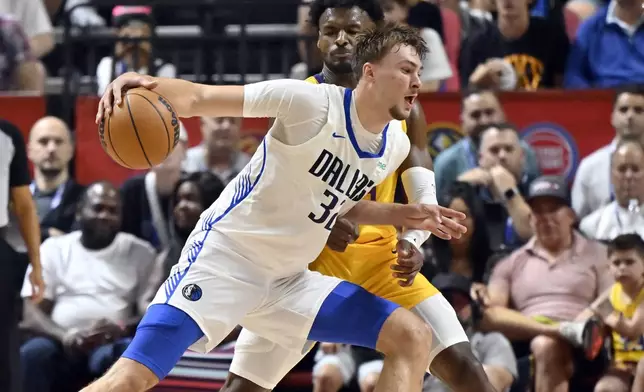 Dallas Mavericks forward Cooper Flagg (32) drives the ball against Los Angeles Lakers guard Bronny James (9) during the first half of an NBA summer league basketball game Thursday, July 10, 2025, in Las Vegas. (AP Photo/David Becker)