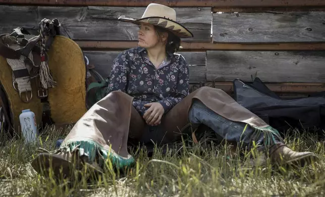 Emma Eastwood, of Calgary, visualizes her ride before competing in women's ranch bronc during rodeo action in Crossfield, Alberta, Saturday, June 14, 2025. (Jeff McIntosh/The Canadian Press via AP)