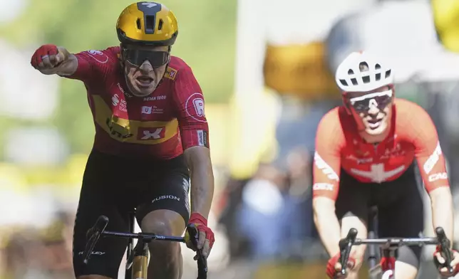 Norway's Jonas Abrahamsen, left, celebrates as he crosses the finish line to win the eleventh stage of the Tour de France cycling race over 156.8 kilometers (97.4 miles) with start and finish in Toulouse, France, Wednesday, July 16, 2025. (AP Photo/Thibault Camus)