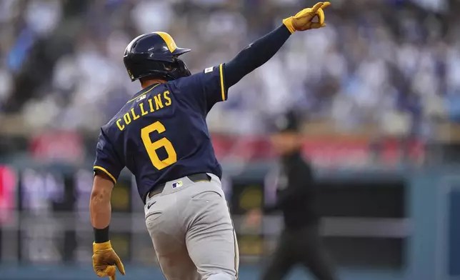 Milwaukee Brewers' Isaac Collins gestures as he rounds first after hitting a solo home run during the fourth inning of a baseball game against the Los Angeles Dodgers, Saturday, July 19, 2025, in Los Angeles. (AP Photo/Mark J. Terrill)