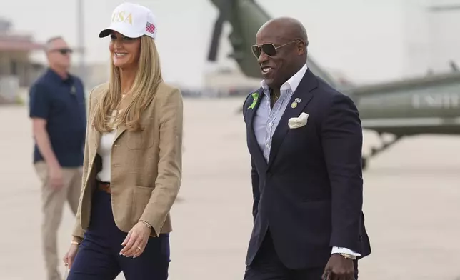 Small Business Administration Chief Kelly Loeffler, left, and Rep. Wesley Hunt, R-Texas, arrive at Kelly Field air base in San Antonio, Texas, en route to observe flood damage in Kerrville, Texas, Friday, July 11, 2025. (AP Photo/Jacquelyn Martin)