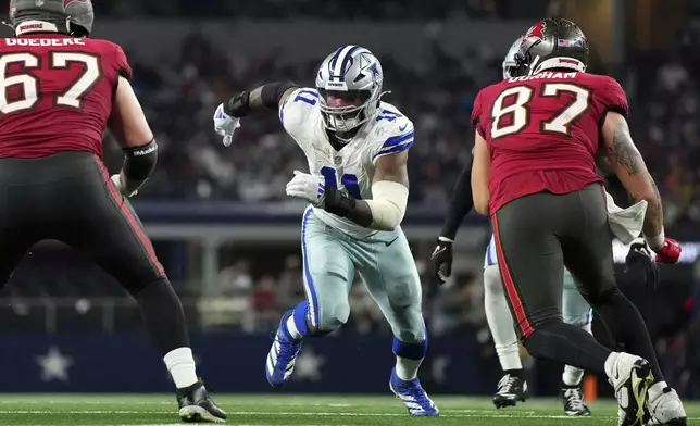 FILE - Dallas Cowboys linebacker Micah Parsons (11) rushes against Tampa Bay Buccaneers offensive tackle Luke Goedeke (67) and tight end Payne Durham (87) during the second half of a football game Sunday, Dec. 22, 2024, in Arlington, Texas. (AP Photo/Jeffrey McWhorter, File)