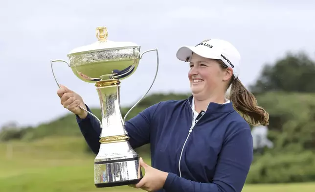 England's Lottie Woad holds the trophy after winning the Women's Scottish Open at the Dundonald Links, Irvine, Scotland, Sunday July 27, 2025. (Steve Welsh/PA via AP)