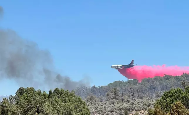 This photo provided by the Bureau of Land Management shows aerial resources working to suppress White Sage wildfire burning north of Grand Canyon National Park in Ariz., on Thursday, July 10, 2025. (Bureau of Land Management, Arizona State Office via AP)