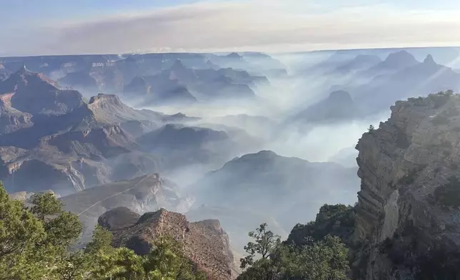 In this photo provided by the National Park Service, smoke from wildfires settles over Grand Canyon National Park in northern Arizona on Friday, July 11, 2025. (Joelle Baird/Grand Canyon National Park)