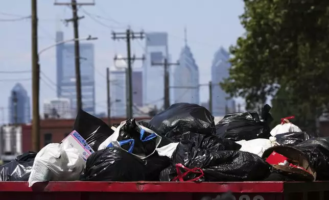 Trash piles up at a garbage collection site, Thursday, July 3, 2025, in Philadelphia. (AP Photo/Matt Slocum)
