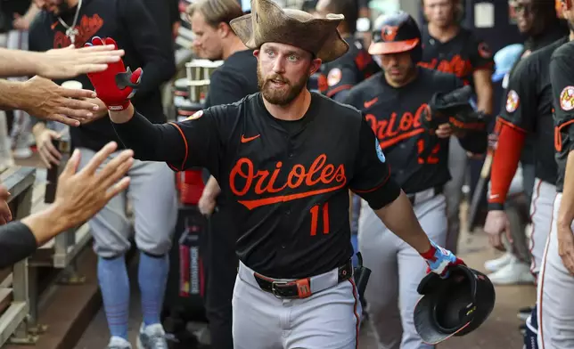 Baltimore Orioles' Jordan Westburg high-fives teammates in the dugout after hitting a solo home run in the third inning of a baseball game against the Atlanta Braves, Friday, July 4, 2025, in Atlanta. (AP Photo/Colin Hubbard)