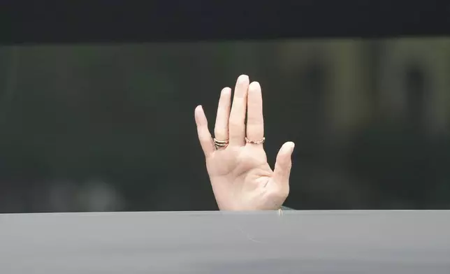 Thailand's Prime Minister Paetongtarn Shinawatra waves as she leaves Government House in Bangkok, Thailand, Tuesday, July 1, 2025, after Thailand's Constitutional Court suspended the prime minister from office pending an investigation over a leaked phone call with a former Cambodian leader. (AP Photo/Sakchai Lalit)