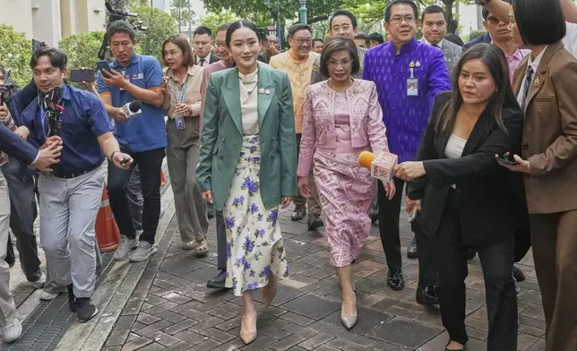 Thailand's Prime Minister Paetongtarn Shinawatra, center, arrives at Government House for a cabinet meeting in Bangkok, Thailand, Tuesday, July 1, 2025. (AP Photo/Sakchai Lalit)