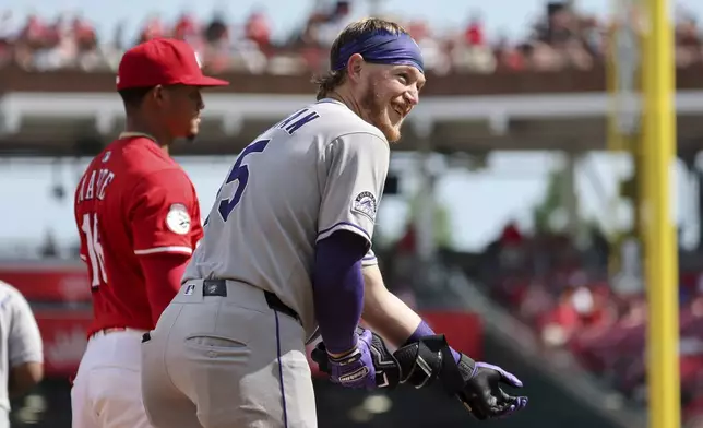 Colorado Rockies' Hunter Goodman (15) celebrates a triple during the fourth inning of a baseball game against the Cincinnati Reds, Saturday, July 12, 2025, in Cincinnati. (AP Photo/Joe Maiorana)