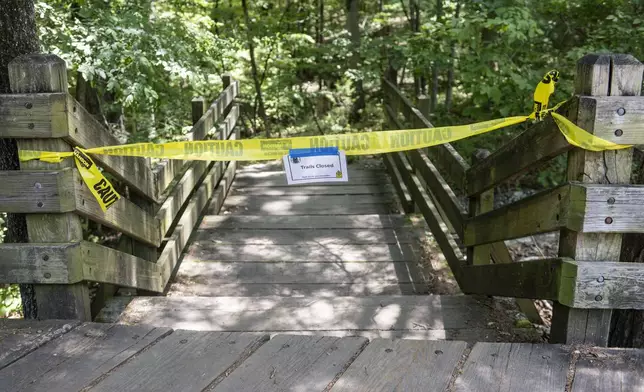 The trail head to the Devil's Den trail at Devils Den State Park remains closed Monday, July 28, 2025, in West Fork, Ark. Police in Arkansas are searching for a suspect in the deaths of a couple who investigators said were attacked while on the wooded walking trail with their two young daughters. (AP Photo/Michael Woods)