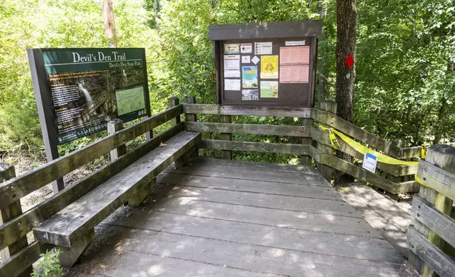 The trail head to the Devil's Den trail at Devils Den State Park remains closed Monday, July 28, 2025, in West Fork, Ark. Police in Arkansas are searching for a suspect in the deaths of a couple who investigators said were attacked while on the wooded walking trail with their two young daughters. (AP Photo/Michael Woods)
