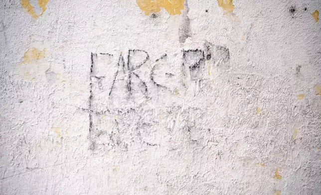 Graffiti on a building reads FARC, the leftist guerrilla group that signed a peace agreement with the government almost a decade ago, on July, 19, 2025, in the Lopez Adentro reserve in Caloto, Colombia. (AP Photo/Nadège Mazars)