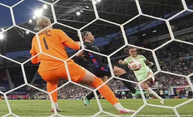 Italy's Barbara Bonansea, right, scores her side's opening goal during the Women's Euro 2025 semifinals soccer match between England and Italy at Stade de Geneve in Geneva, Switzerland, Tuesday, July 22, 2025. (AP Photo/Martin Meissner)