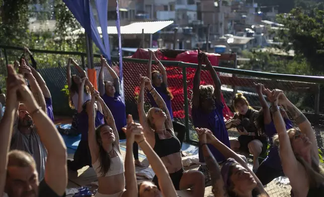 People attend a Transformation Project yoga class in the Rocinha favela, in Rio de Janeiro, Wednesday, July 9, 2025. (AP Photo/Bruna Prado)