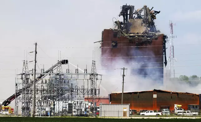 Firefighters battle a fire after an explosion in an industrial area in Fremont, Neb., Tuesday, July 29, 2025. (Chris Machian/Omaha World-Herald via AP)