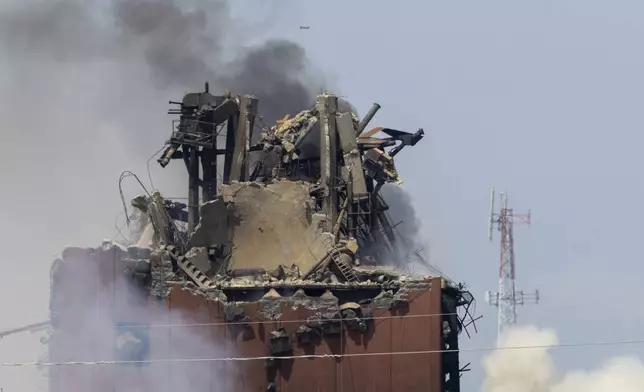 A drone is seen above as firefighters battle a fire after an explosion in an industrial area in Fremont, Neb., Tuesday, July 29, 2025. (Chris Machian/Omaha World-Herald via AP)