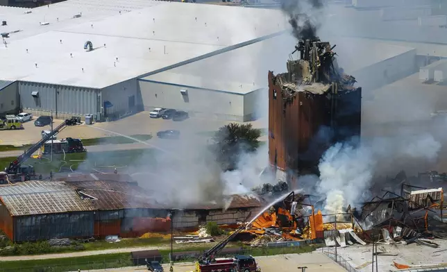 Firefighters battle a fire after an explosion in an industrial area in Fremont, Neb., Tuesday, July 29, 2025. (Chris Machian/Omaha World-Herald via AP)