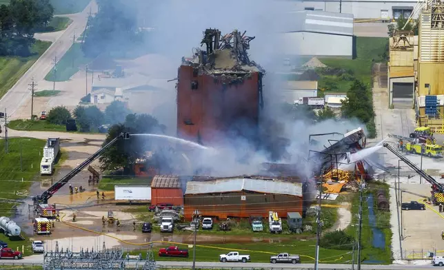 Firefighters battle a fire after an explosion in an industrial area in Fremont, Neb., Tuesday, July 29, 2025. (Chris Machian/Omaha World-Herald via AP)