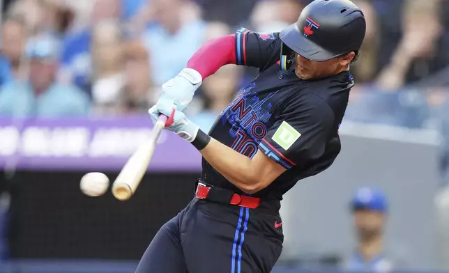 Toronto Blue Jays' Joey Loperfido (10) hits an RBI double against the San Francisco Giants during the second inning of a baseball in Toronto, Friday, July 18, 2025. (Nathan Denette/The Canadian Press via AP)